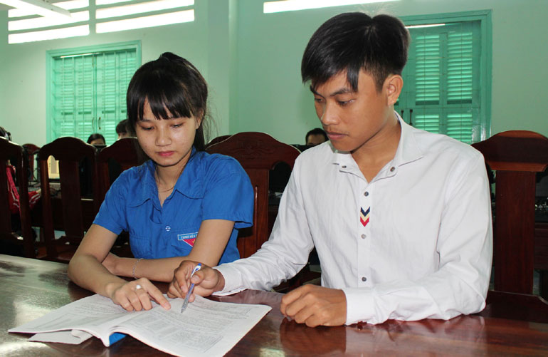 Nguyễn Hữu Nghĩa (phải) trao đổi ý tưởng làm dự án “Trồng vườn dược liệu” với một bạn sinh viên tại Thư viện Trường cao đẳng Y tế Phú Yên - Ảnh: TRUNG HIẾU